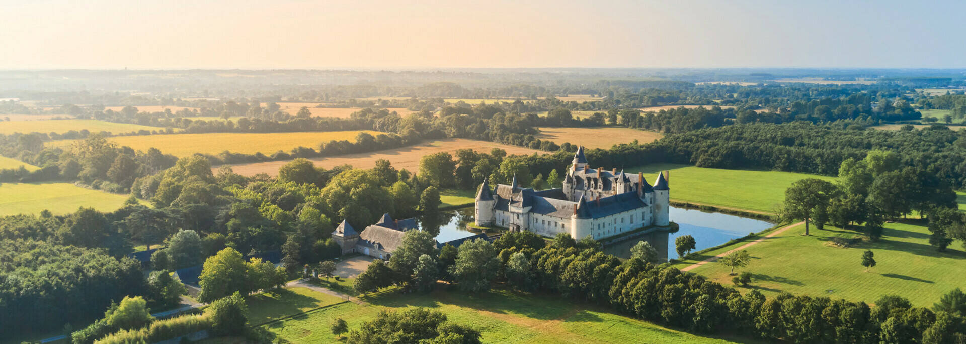 Aerial view of the château, its moat and the surrounding landscapes