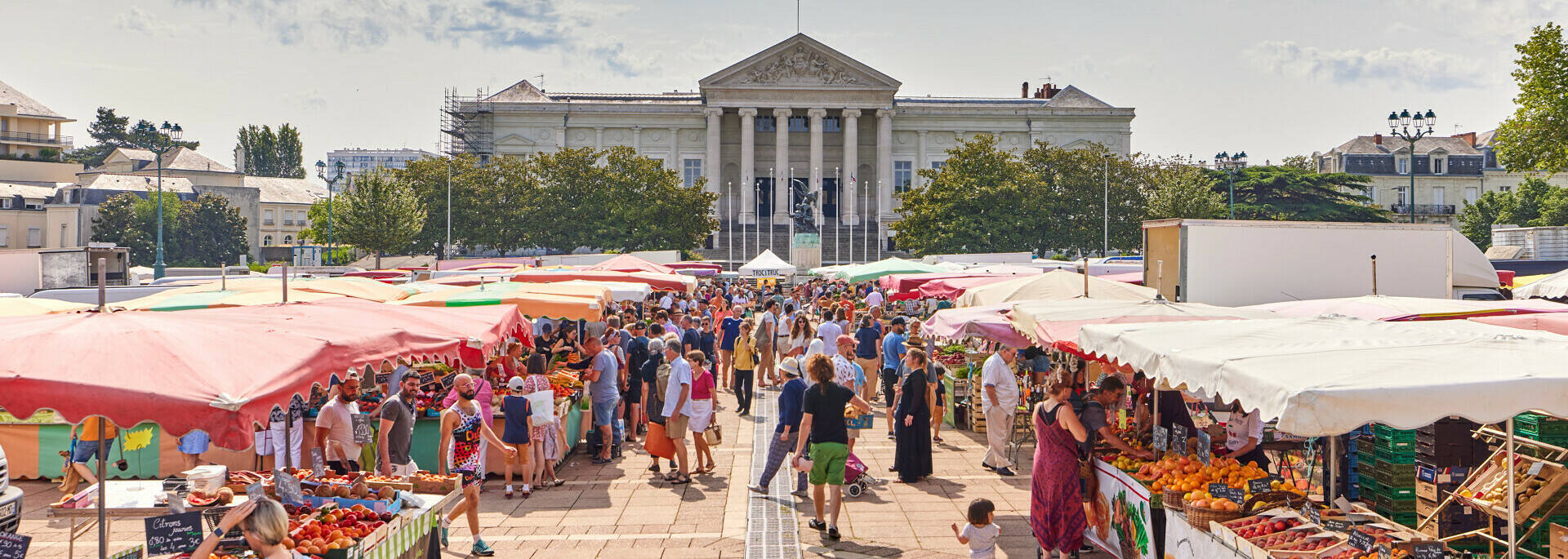 Plan large du marché et de ses étals, place Leclerc, le palais de justice à l'arrière-plan