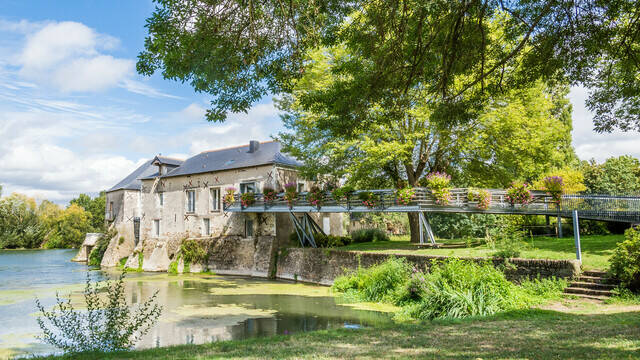 Wide shot of the mill on the banks of the Loir, spring sunshine, nice green vegetation 