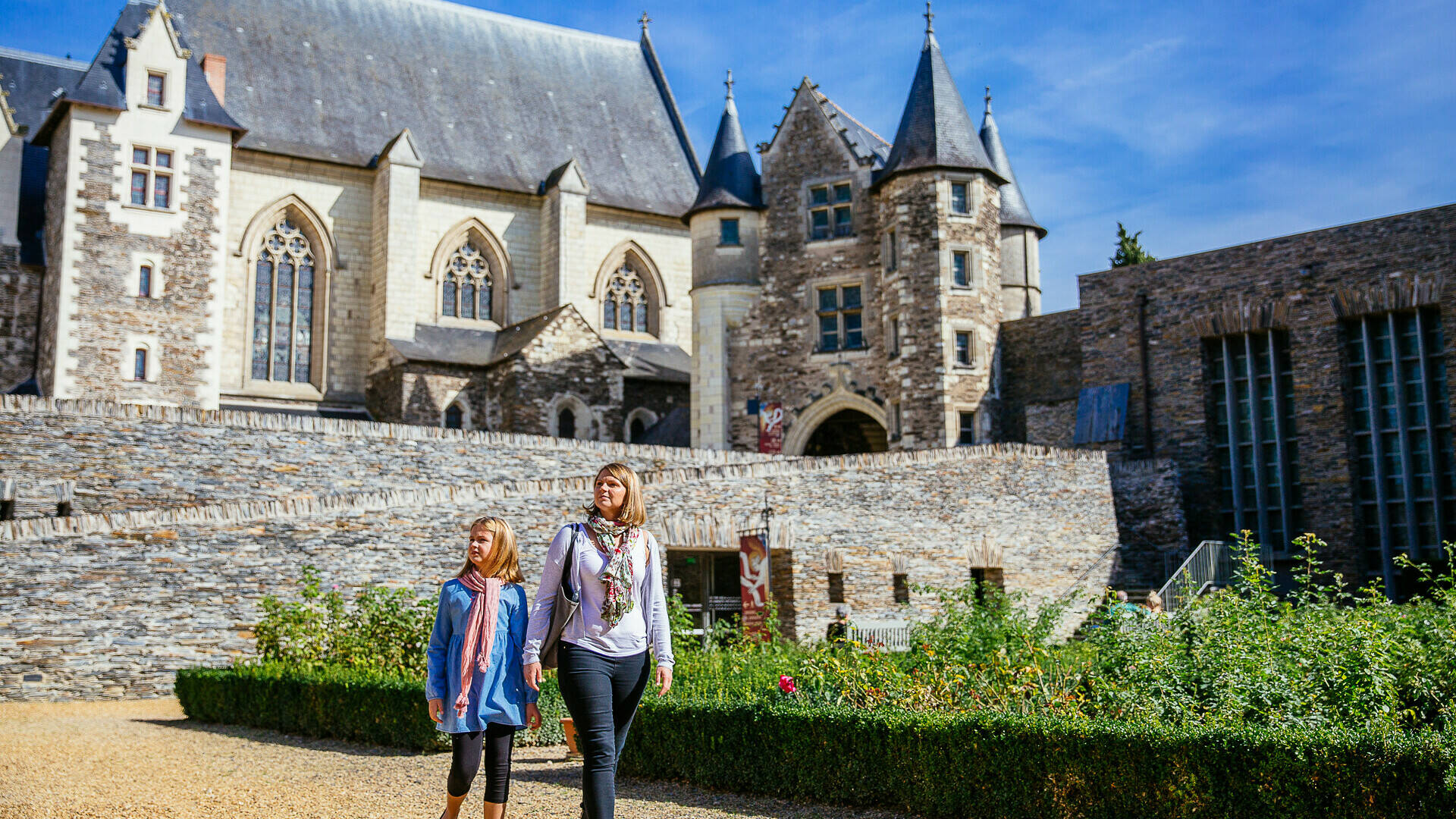 A mother and daughter walking near the Gallery of the Apocalypse